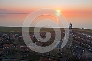 Aerial from the historical village Hindeloopen at the IJsselmeer in the Netherlands at sunset