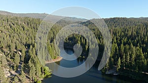 Aerial of Hume Lake reservoir surrounded by a big forest in the Kings Canyon Sequoia National Park