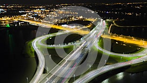 Aerial hyperlapse time lapse of a highway intersection motor way at night traffic commuter cars trucks transportation