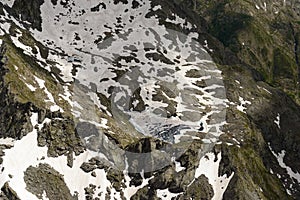 Aerial of ice melting on small mountain lake, Orobie