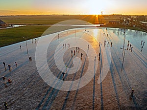 Aerial from ice skating at sunset on the ice rink in Koudum Friesland the Netherlands