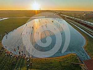 Aerial from ice skating at sunset on the ice rink in Koudum Friesland the Netherlands photo