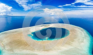Aerial idyllic atoll, scenic travel destination Maldives Polinesia. Blue lagoon and turquoise coral reef. Shot in Wakatobi