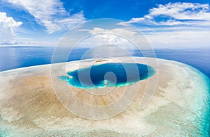 Aerial idyllic atoll, scenic travel destination Maldives Polinesia. Blue lagoon and turquoise coral reef. Shot in Wakatobi