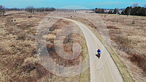 Aerial iew cyclist is engaged in a healthy lifestyle. Bike ride in the Park. A quadrocopter that follows the cyclist.