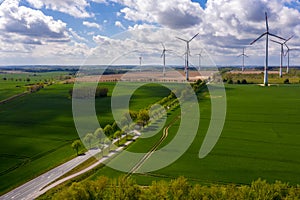 Aerial image of agricultural fields with windmills or wind turbines