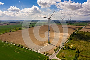 Aerial image of agricultural fields with windmills or wind turbines