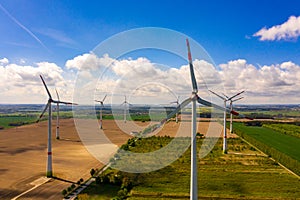 Aerial image of agricultural fields with windmills or wind turbines