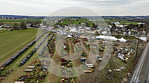 Aerial image of Amish Mud Sale, shows a display farm machinery, equipment rural exhibition field