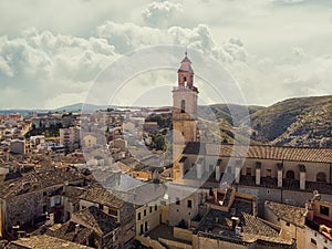 Aerial image ancient architecture view of Bocairent against hills and cloudy sky background photo