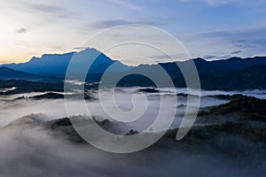 Aerial image of beautiful fresh green nature landscape scene of tropical rainforest and clouds during morning sunrise