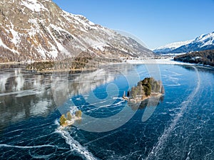 Aerial image of the Chaviolas islets on the frozen lake , St. Moritz, Switzerland