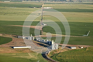 An aerial image of farm fields and grain silos in the Idaho farm fields.