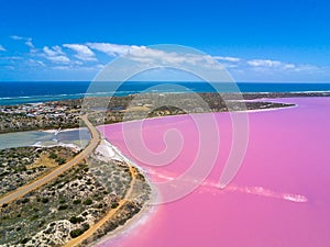 Aerial image of the Pink Lake and Gregory in Western Australia with Indian Ocean in background