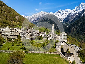 Aerial image of the Swiss mountain village Solio with the snow-capped Sciora range at the background