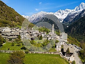 Aerial image of the Swiss mountain village Solio with the snow-capped Sciora range at the background photo