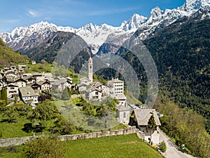 Aerial image of the Swiss mountain village Solio with the snow-capped Sciora range photo