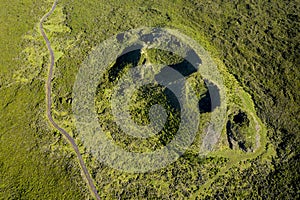 Aerial image of typical green volcanic caldera crater landscape with volcano cones of Planalto da Achada central plateau of Ilha photo