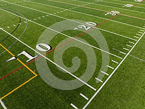 Aerial image of a typical synthetic turf football field 10 yard line in white.