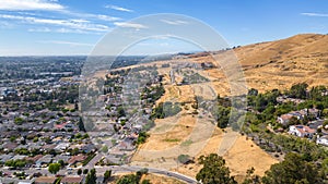 Aerial images over a neighborhood in Hayward, California with a blue sky and room for text photo