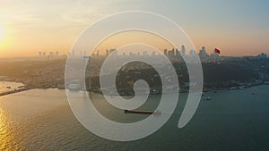 Aerial: Istanbul Bosphorus Bridge at Sunset, large freight ship sailing under