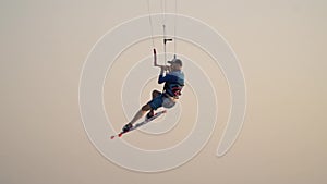 Aerial jump by a kitesurfer, flying in the air, stunts and tricks