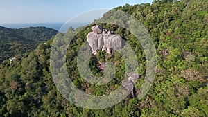 Aerial Koh Tao, Thailand bouldering on island mountain with man jumping on rocks