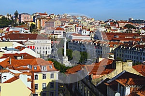 Aerial landscape of city center of Lisbon. View from top of Santa Justa Lift. Vintage buildings with red tile roofs. Rossio Square