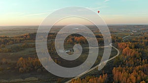 Aerial landscape with colorful hot air balloons flying over forests