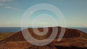 Aerial landscape of desert land with ocean in background