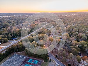 Aerial landscape of forest and suburban area road and leisure courts at sunset in Augusta Georgia