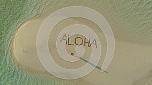 Aerial landscape of lovely travel couple relaxing on the white beach of tropical island in Philippines