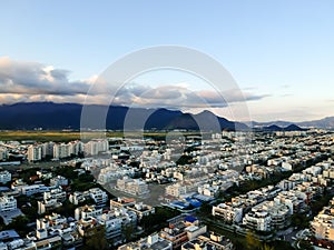 Aerial landscape photo of Recreio dos Bandeirantes during sunset, with all the residential buildings forming a grid