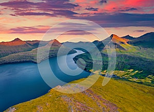 Aerial landscape photography. Great sunset on Faroese fjords in the outskirts of Funningur village.