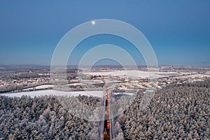 Aerial landscape of the road through snowy forest at winter, Poland