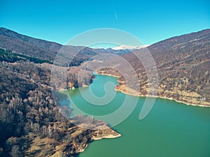 Aerial landscape shot of a mountain lake in early spring