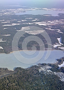 Aerial landscape snowy winter view of forest and lake