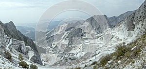 Aerial landscape of valley with bending roads and marble quarrys, Carrara, Italy