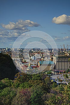 Aerial landscape view of ancient Podil neighborhood. Streets with colorful buildings against blue sky