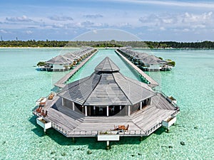 Aerial landscape view of the beautiful over water wooden hut in the ocean at the tropical island