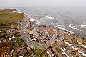 Aerial landscape view of Craster Harbour and village in Northumberland