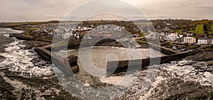 Aerial landscape view of Craster Harbour and village in Northumberland photo