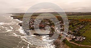 Aerial landscape view of Craster Harbour and village in Northumberland photo