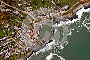 Aerial landscape view directly above  Craster Harbour and village in Northumberland photo