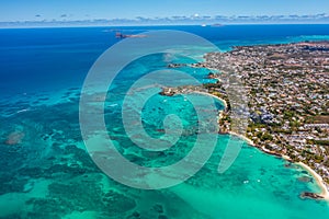 Aerial landscape view of Grand Bay, the infrastructure and buildings along the coastline, many boats on water