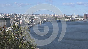 Aerial landscape view of Kyiv. Podil neighborhood. River Dnipro with several bridges at the background. Windy autumn day in Kyiv.