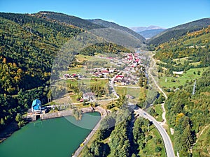 Aerial landscape view of a mountain village at the beginning of autumn