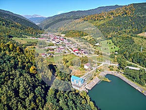 Aerial landscape view of a mountain village at the beginning of autumn