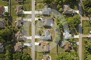 Aerial landscape view of suburban private houses between green palm trees in Florida quiet rural area