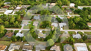 Aerial landscape view of suburban private houses between green palm trees in Florida quiet rural area